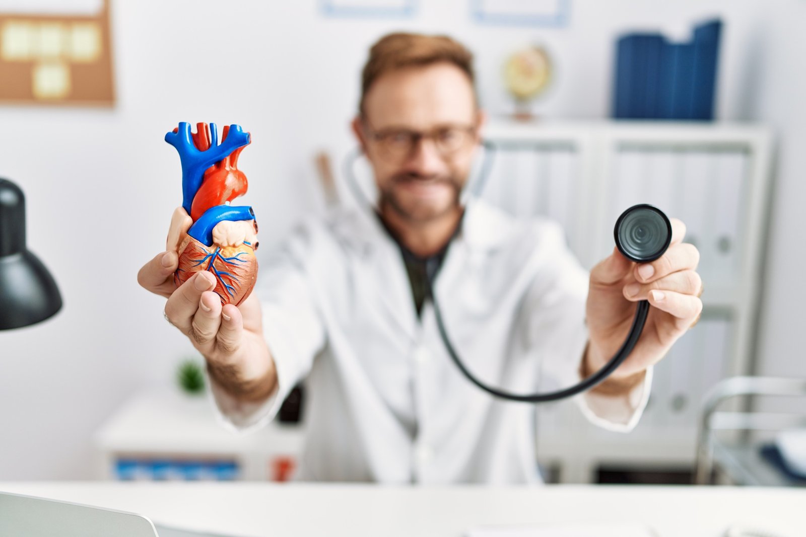 Middle age hispanic man wearing doctor uniform auscultating heart at clinic