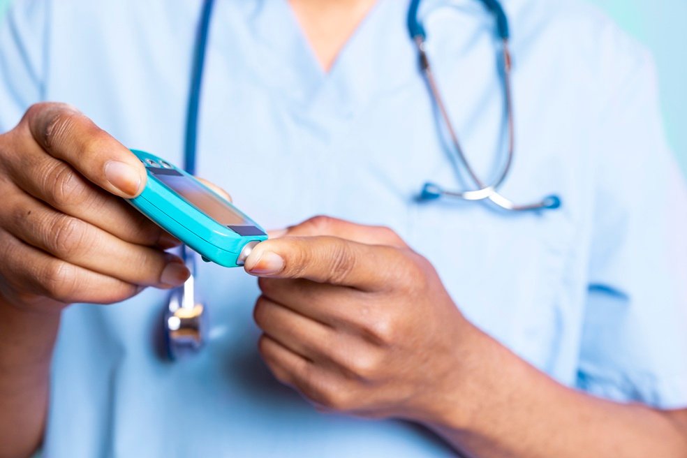 Medical expert measuring sugar from blood with a finger prick